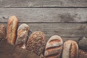 Bread bakery background. Brown and white wheat grain loaves comp